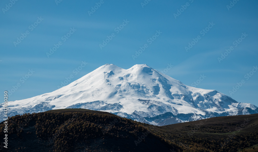 Elbrus And Green Hills At Sunny Summer Day. Elbrus Region, North Caucasus, Russia Elbrus And Green Hills At Sunny Summer Day. Elbrus Region, North Caucasus, Russia