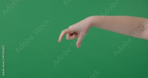 Woman hand cathching something on green screen