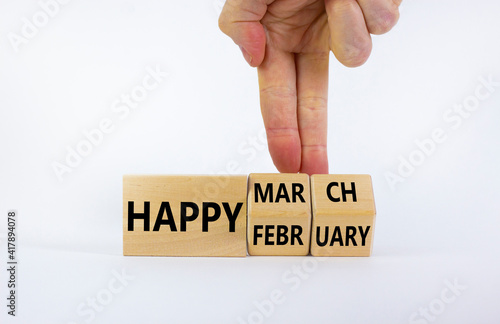 Wallpaper Mural Symbol for the change from February to March. Businessman turns wooden cubes and changes words 'Happy February' to 'Happy March'. Beautiful white background, copy space. Happy March concept. Torontodigital.ca