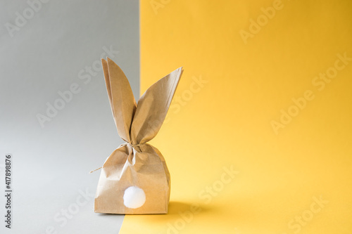 Photography Easter bunny paper gift egg wrapping DIY idea on colorful background