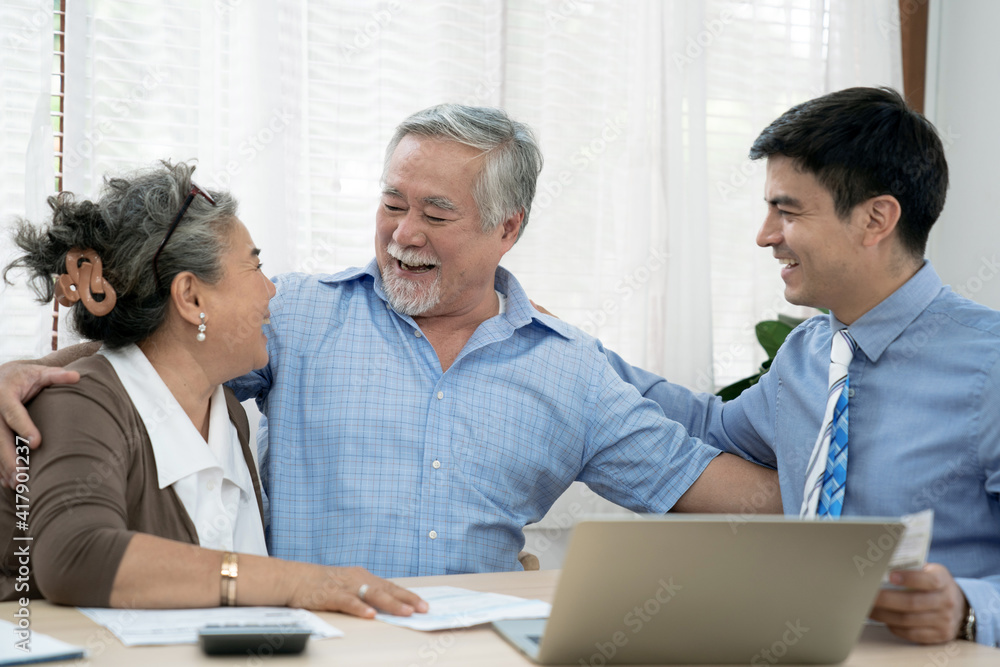 An insurance agent offers health insurance for Asian elderly couples, Finance staff present and close real estate sales. An insurance agent offers health insurance for Asian elderly couples, Finance staff present and close real estate sales.