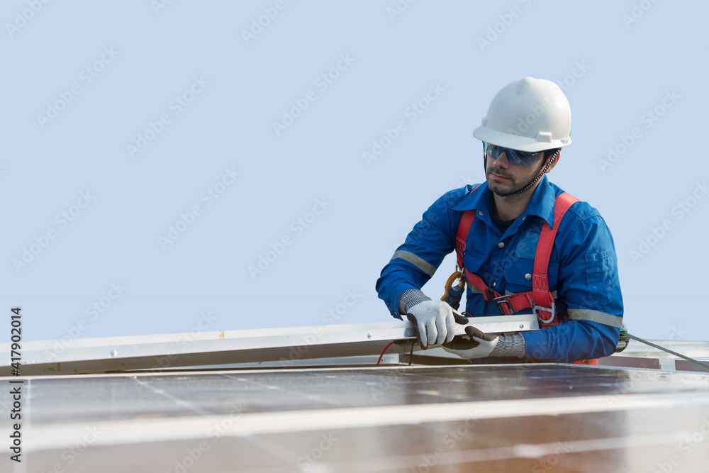 A technician installing the solar panels at roof top of home and home office ,concept of economic energy and cost saving ,own small business A technician installing the solar panels at roof top of home and home office ,concept of economic energy and cost saving ,own small business