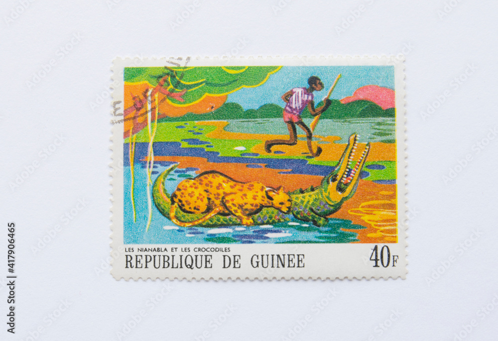 Guinea Republic Postage Stamp. circa 1968. the jaguar and the crocodiles
