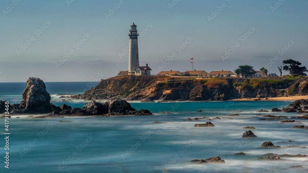 Long exposure showing the rocks and cliffs at Pigeon Point Lighthouse on a clear beautiful day 