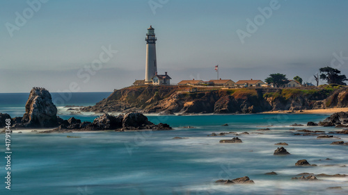 Long exposure showing the rocks and cliffs at Pigeon Point Lighthouse on a clear beautiful day 