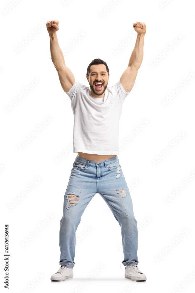 Full length portrait of a man in jeans and white t-shirt gesturing happiness with raised arms Full length portrait of a man in jeans and white t-shirt gesturing happiness with raised arms