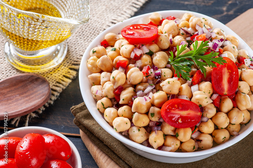 .Delicious chickpea salad with tomatoes, onions, peppers and parsley
