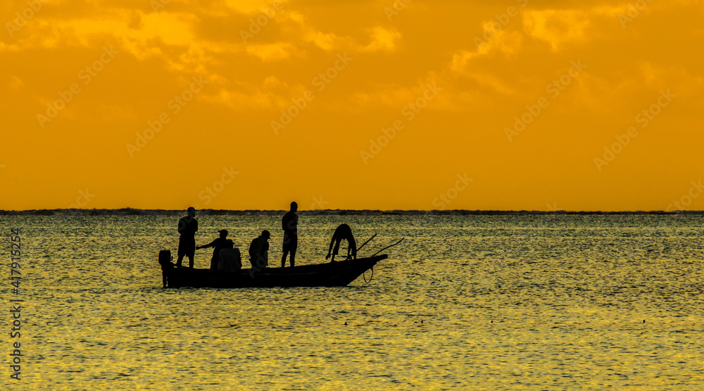 A traditional native nagalawa at sunrise. The ngalawa or ungalawa is a traditional, double-outrigger canoe of the Swahili people living in Zanzibar
