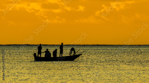 A traditional native nagalawa at sunrise. The ngalawa or ungalawa is a traditional, double-outrigger canoe of the Swahili people living in Zanzibar