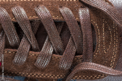 Fragment of men's leather loafers of brown color, close-up. 