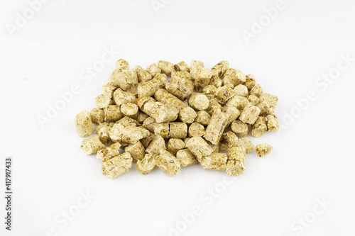 Pile of wood litter for animal toilet on white surface photo