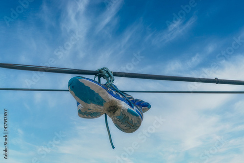 Shoes hanging on cables as spot sign of drug dealing