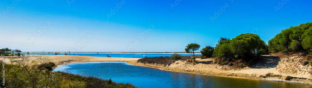Panoramic of El Portil beach with sky clouds