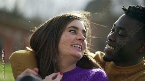 Happy interracial couple laughing and smiling together. ethnically diverse couple real life smile and laugh