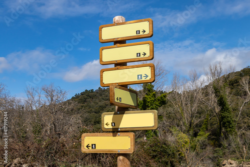 Wooden Directional Trail Sign in Mountain with different hiking trails in Santa Ana la Real  Huelva  Spain