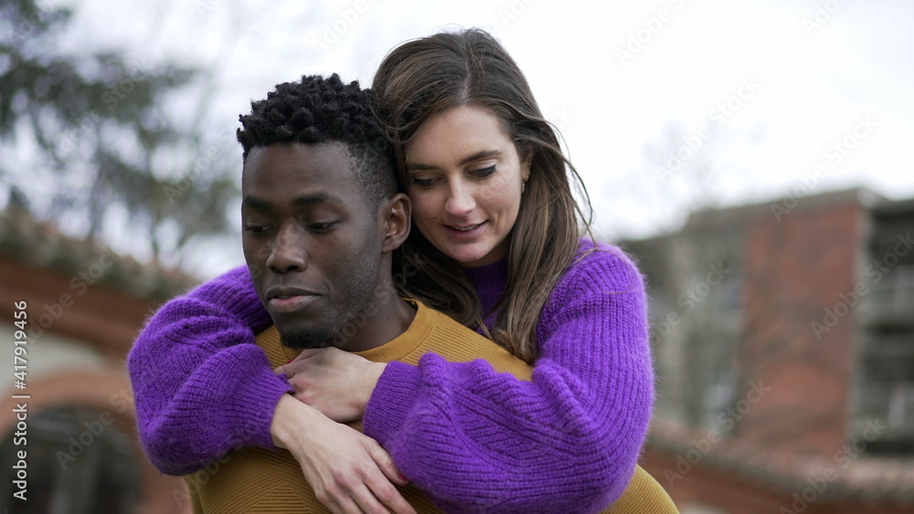 Happy millennial couple together. Black boyfriend carrying girlfriend in back Happy millennial couple together. Black boyfriend carrying girlfriend in back