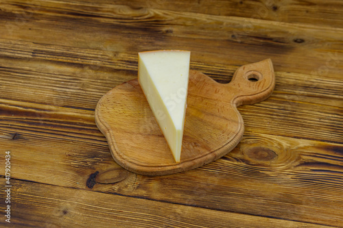 Piece of cheese on a wooden table