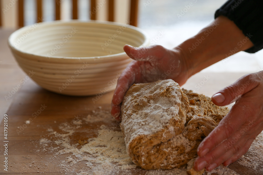 Fototapeta premium Hands of woman kneading sourdough