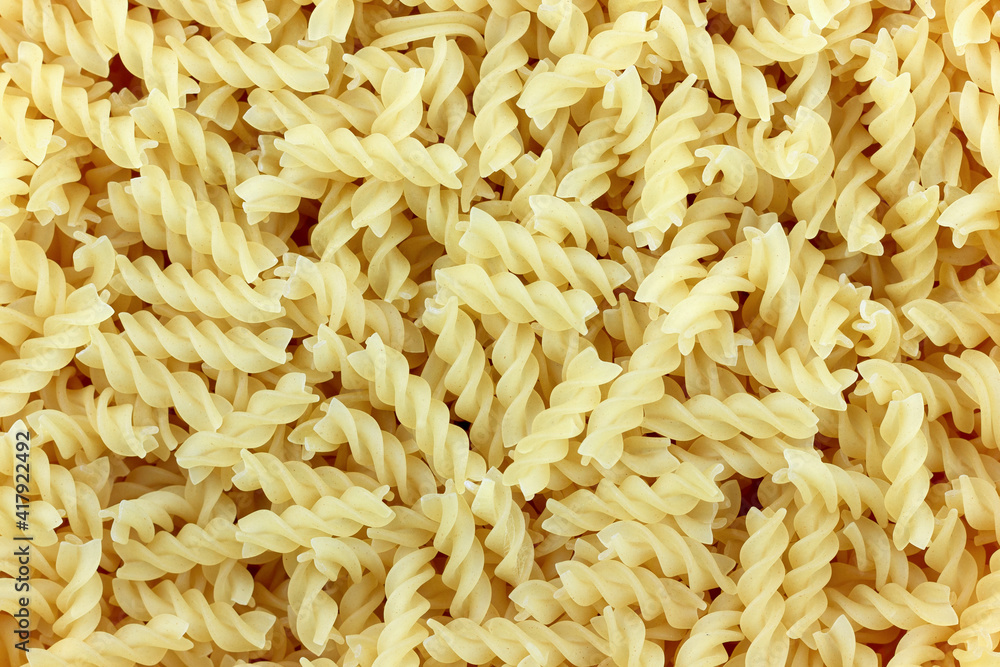 Close-up of raw pasta, texture or background, spiral pasta Close-up of raw pasta, texture or background, spiral pasta