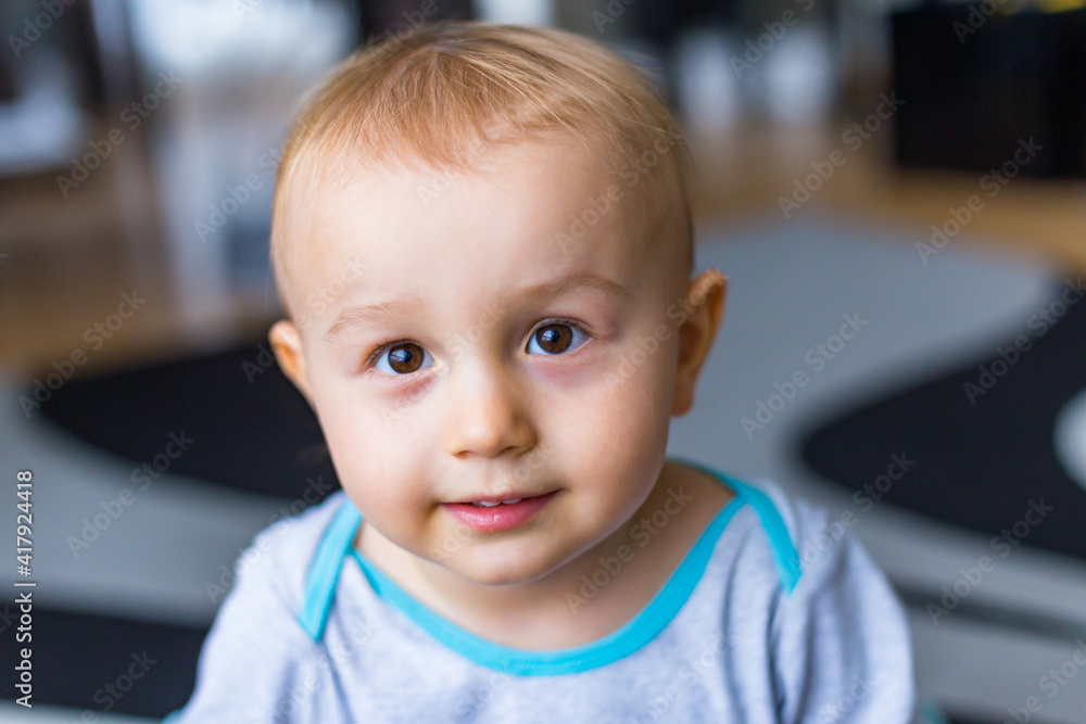 Close up portrait of a toddler boy of two years old staying at home. Funny child looking with wide opened eyes at the camera. Close up portrait of a toddler boy of two years old staying at home. Funny child looking with wide opened eyes at the camera.
