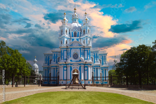 Smolny Cathedral in Saint-Petersburg against a beautiful sky. Multicolored clouds over St. Petersburg. Smolny Cathedral in summer. Orthodox shrines of Russia. Russian Federation cities. photo