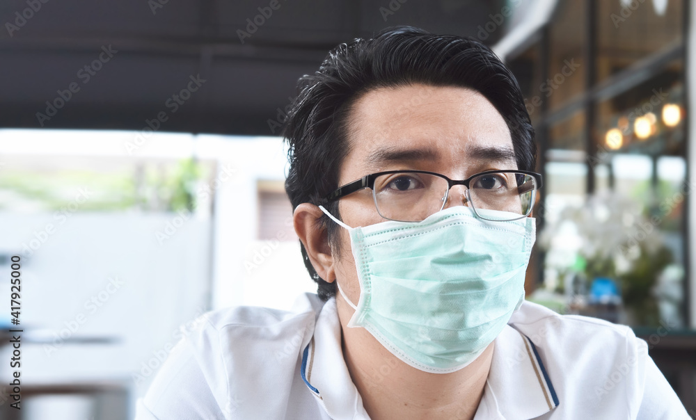 Asian men wearing mask for protect air pollution, and coronavirus concept Asian men wearing mask for protect air pollution, and coronavirus concept