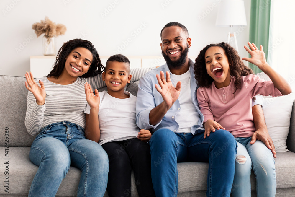 Portrait of a happy black family waving hands at camera Portrait of a happy black family waving hands at camera