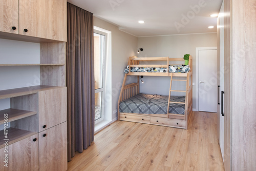 Canvas Print Children's bedroom in new luxury home with bunk beds and colorful comforters