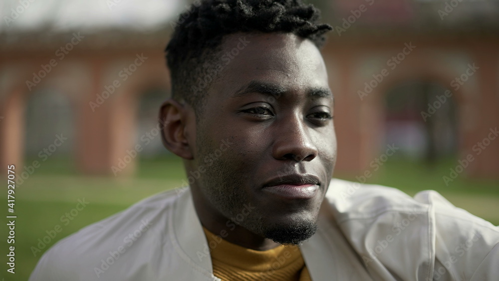 Young black man portrait face speaking with female friend. African guy sitting at park Young black man portrait face speaking with female friend. African guy sitting at park