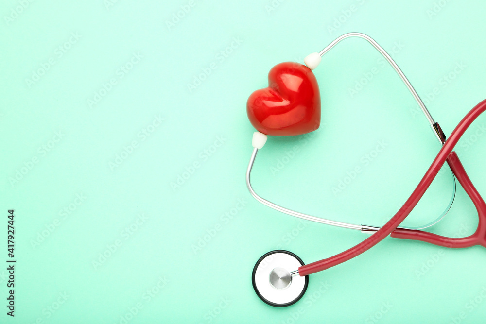 Stethoscope with red heart on mint background Stethoscope with red heart on mint background