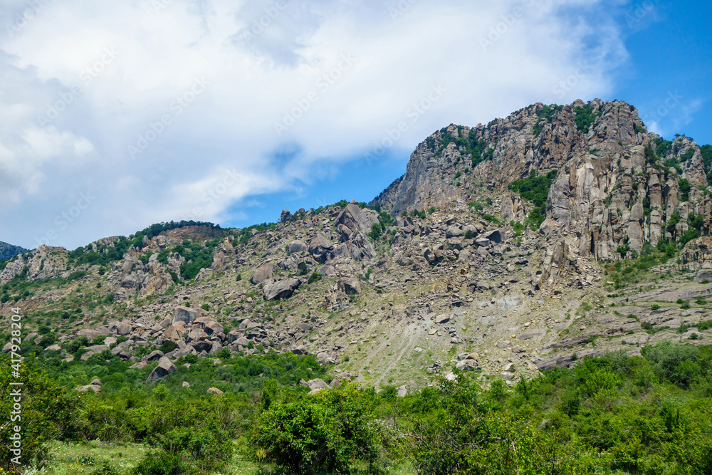 Overview of tall mountains & massive fallen multi-ton boulders in Valley of Ghosts, near Alushta, Crimea