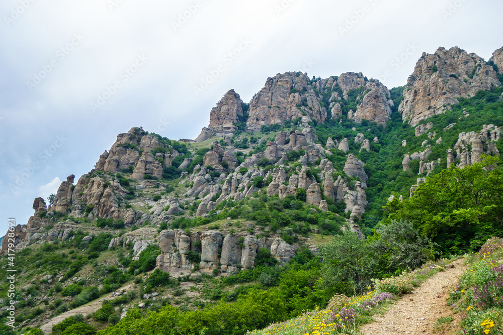 Panorama of mountains in Valley of Ghosts, near Alushta. Popular place for hiking among tourists because of scenic views. In right corner possible to see trekking trail