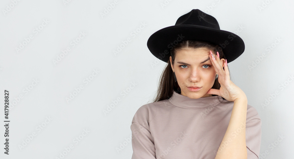 The face of an angry disgruntled young woman, looking at the camera. White isolated background. The face of an angry disgruntled young woman, looking at the camera. White isolated background.