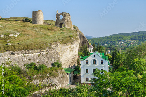 Panorama of St Clement Male Monastery buildings and remains of medieval fortress Kalamita, Inkerman, Crimea. Temple on front is Trinity Church, rock behind hides inside cave Church of Saint Clement photo