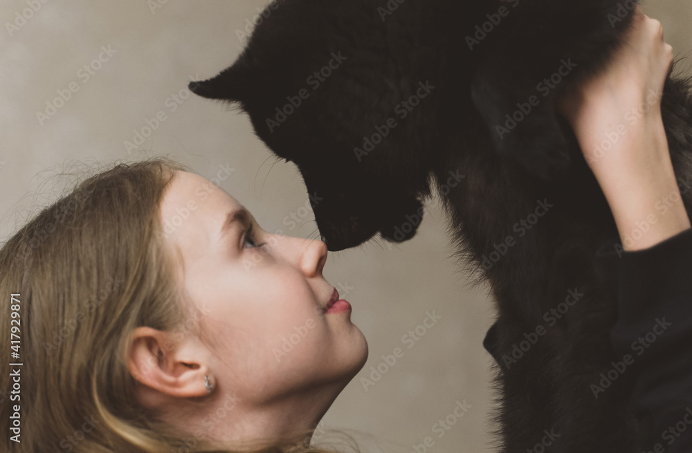 Portrait of tween girl with Schipperke puppy. Portrait of tween girl with Schipperke puppy.