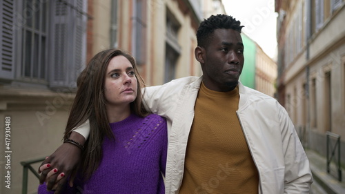 Young romantic interracial couple walking outside in european city