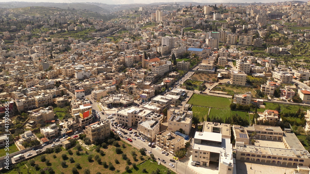 Aerial view over Bethlehem City, Palestinian Authority
Drone view over buildings and fields in the morning, March 2021
