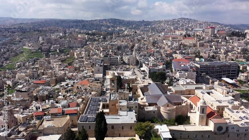 Aerial view over Church of the Nativity And City Square Of Bethlehem
, Morning shot from Bethlehem, the town where Jesus was born. Place of The Church of the Nativity
 photo