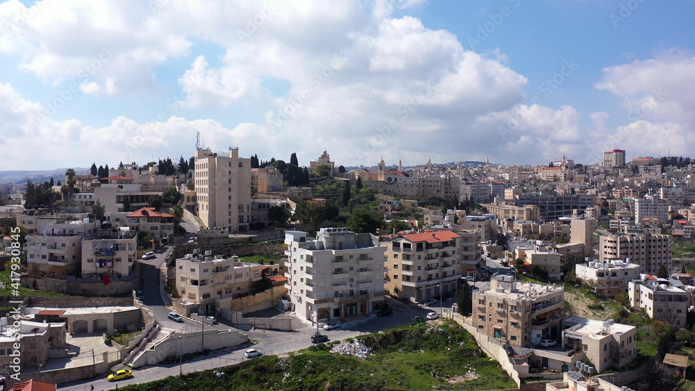 Aerial view over Bethlehem City, Palestinian Authority
Drone view over buildings and traffic in the morning, March 2021
