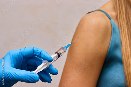Syringe with vaccine in doctor s hand. Doctor is going to inject a vaccine. 