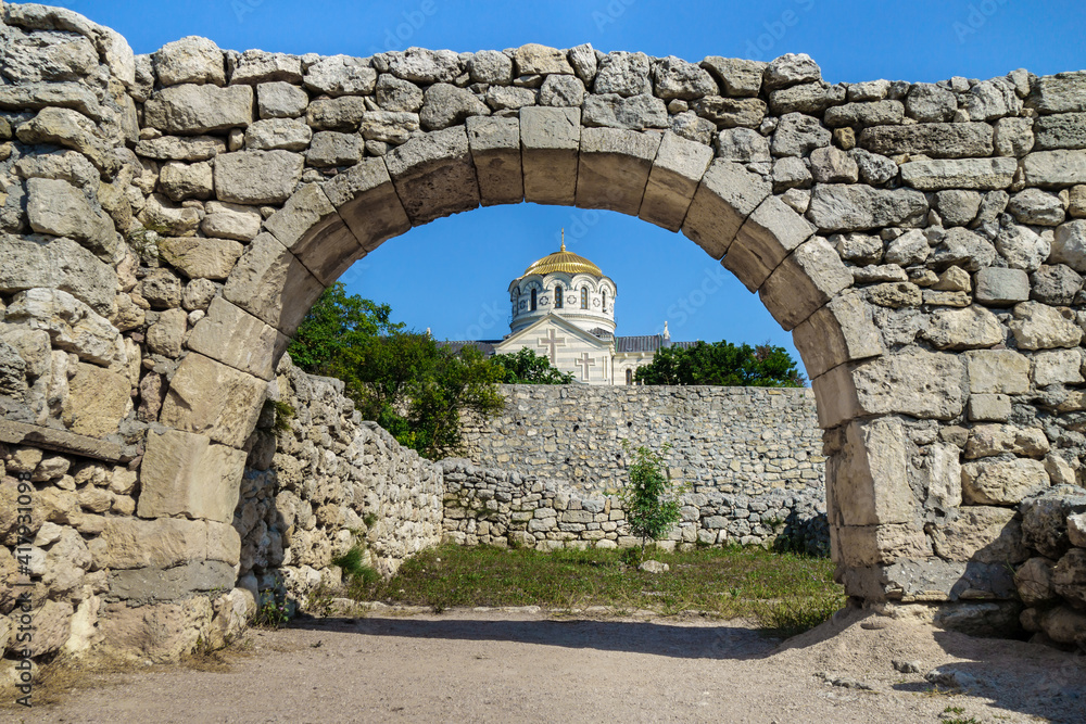 Golden dome of Vladimir's Cathedral as it looks through the street arch in antique city Chersonesus, Sevastopol, Crimea