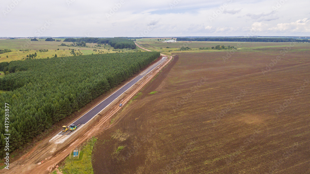 Drone view of the new road. Aerial photography construction of a new highway. Construction stage. Road pavement layers. The composition of the road during its construction