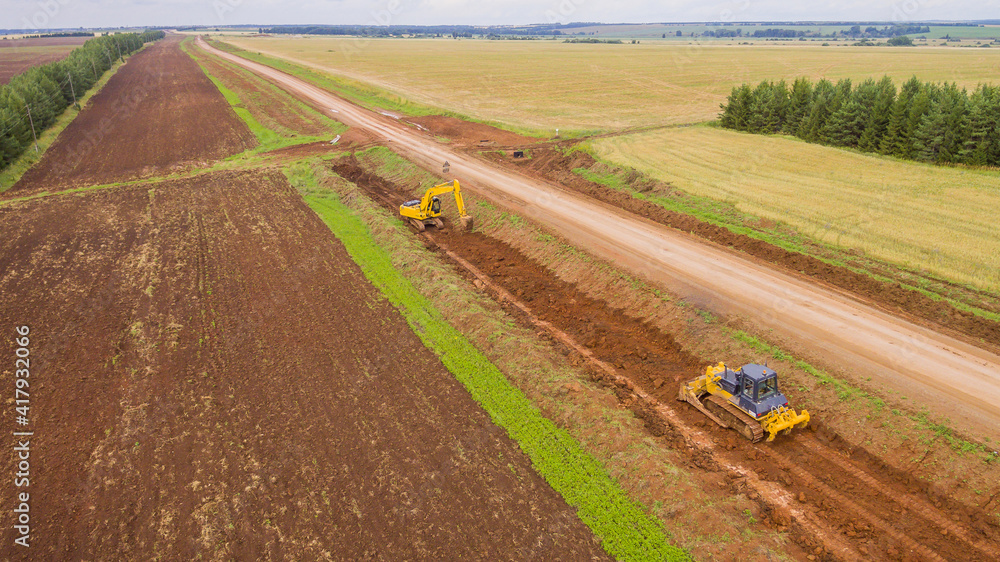 Fototapeta premium Drone view of the new road. Aerial photography construction of a new highway. Construction stage. Road pavement layers. The composition of the road during its construction