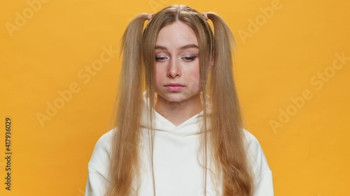 What? Gesture Confused Young teen girl shows emotion. Spreading his hands in front of camera with chagrin on yellow background. Fashion. Monotone. Emotions People. Lifestyle