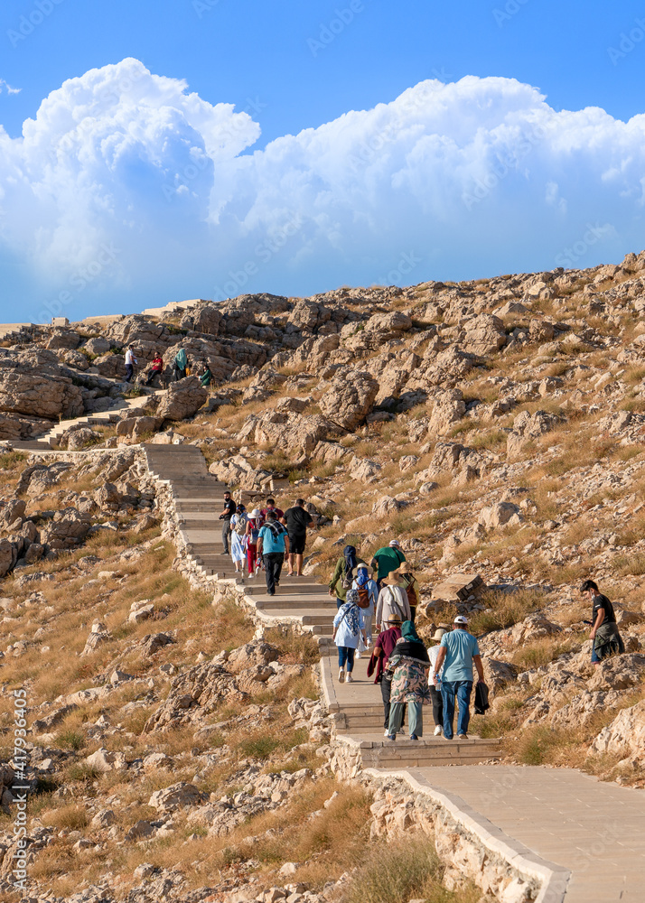 Kahta, Adiyaman, Turkey - September 14 2020: Tourists walking to climb the mountain on the trail to Nemrut Mountain
