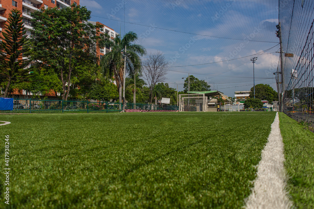 Green grass soccer field in the city. Soccer line.