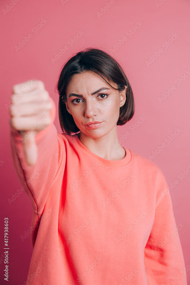 Woman wearing casual sweater on background looking unhappy and angry showing rejection and negative with thumbs down gesture. Bad expression. Woman wearing casual sweater on background looking unhappy and angry showing rejection and negative with thumbs down gesture. Bad expression.