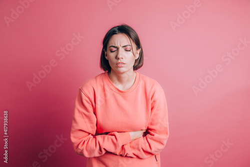 Картината върху платно Woman wearing casual sweater on background suffering stomach ache with painful g