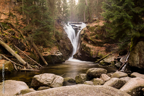 Mountain waterfall in a green forest during fall. Forest water cascade. Waterfall Kamienczyk, Szklarska Poręba