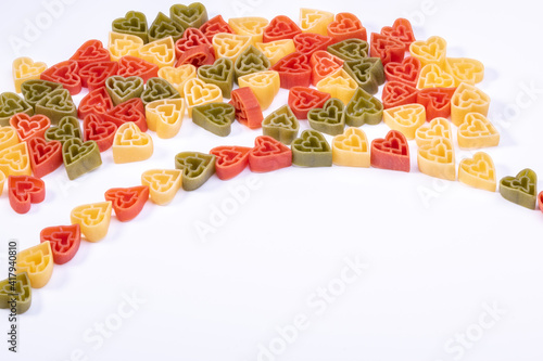Italian ttree color heart shaped pasta on white background with copy space